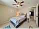 Bedroom featuring a ceiling fan, neutral walls and carpet, and a side table with a vintage-inspired lamp at 10323 W Carousel Dr, Arizona City, AZ 85123