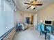 Bedroom featuring a ceiling fan, large window, and study desk with comfortable accent chair at 10323 W Carousel Dr, Arizona City, AZ 85123