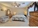 Cozy bedroom featuring a ceiling fan, warm lighting, and comfortable furnishings at 10323 W Carousel Dr, Arizona City, AZ 85123