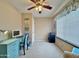 Bedroom featuring a ceiling fan, large window, and study desk with comfortable accent chair at 10323 W Carousel Dr, Arizona City, AZ 85123