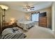 Comfortable bedroom with a ceiling fan, dresser, and warm decor at 10323 W Carousel Dr, Arizona City, AZ 85123