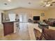 Open living room with tile and carpet flooring and large double doors leading outside at 10323 W Carousel Dr, Arizona City, AZ 85123