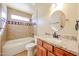 Modern bathroom with granite countertop, updated vanity, tub, and tiled shower at 10720 E Sahuaro Dr, Scottsdale, AZ 85259