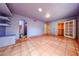 This bedroom provides tile floors, natural light, and easy access to the ensuite bath at 10720 E Sahuaro Dr, Scottsdale, AZ 85259