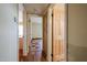 Inviting hallway with hardwood floors and doors leading to rooms with tile flooring at 10720 E Sahuaro Dr, Scottsdale, AZ 85259