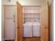 Dedicated laundry closet with storage and convenient shelving at 10720 E Sahuaro Dr, Scottsdale, AZ 85259