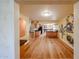 Open-concept living space with hardwood floors and pale yellow walls featuring a painted mural and unique architectural design at 10720 E Sahuaro Dr, Scottsdale, AZ 85259