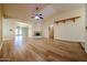 Spacious living room featuring wood floors, decorative fireplace, and seamless flow to dining area at 10720 E Sahuaro Dr, Scottsdale, AZ 85259