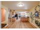 Open-concept living space with hardwood floors and pale yellow walls featuring a painted mural and unique architectural design at 10720 E Sahuaro Dr, Scottsdale, AZ 85259