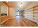 Bright living room with wood floors and built in shelving, seamlessly connecting to other spaces at 10720 E Sahuaro Dr, Scottsdale, AZ 85259