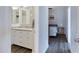 Bathroom with double sink vanity, granite counters, and wood flooring at 1102 E Brown St, Phoenix, AZ 85020