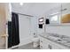 Cozy bathroom with a shower/tub combo, updated vanity, white tile, and neutral gray flooring at 1102 E Brown St, Phoenix, AZ 85020