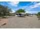 Lovely single-story home with desert landscaping, mature trees, and a gravel yard at 1102 E Brown St, Phoenix, AZ 85020