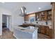 Modern kitchen with custom cabinets, stainless steel appliances, and a granite-topped island at 1102 E Brown St, Phoenix, AZ 85020