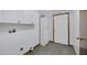 Laundry room featuring white cabinets, neutral walls, and gray flooring at 1102 E Brown St, Phoenix, AZ 85020