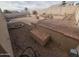 Multi-tiered backyard featuring a brick patio, decorative stone, planters, and privacy fence at 11184 W Royal Palm Rd, Peoria, AZ 85345