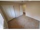 A bedroom featuring tile flooring, a ceiling fan, and a closet with sliding doors at 11184 W Royal Palm Rd, Peoria, AZ 85345