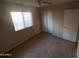 Bright bedroom featuring tile flooring, a ceiling fan, and a sunlit window at 11184 W Royal Palm Rd, Peoria, AZ 85345