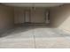 A garage with a hot water heater, concrete floors, and a utility door at 11184 W Royal Palm Rd, Peoria, AZ 85345