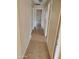 Hallway with tile flooring and neutral walls connecting various rooms at 11184 W Royal Palm Rd, Peoria, AZ 85345