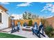 Inviting backyard with a stone-trimmed fire pit surrounded by comfortable chairs, ideal for entertaining and enjoying cool evenings at 11307 E Ellis St, Mesa, AZ 85207