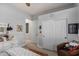 Bedroom featuring a dresser with sewing machine, and a large closet with sliding doors at 11307 E Ellis St, Mesa, AZ 85207