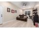 Bonus room features a ceiling fan, wood laminate flooring, and large window at 11307 E Ellis St, Mesa, AZ 85207