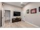 Bonus room features wood laminate flooring, a TV, and a doorway at 11307 E Ellis St, Mesa, AZ 85207