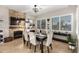 Charming dining room with stone fireplace, and a large window with plantation shutters at 11307 E Ellis St, Mesa, AZ 85207