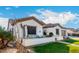 Beautiful single-story home with desert landscaping, lush green lawn, and a cozy front patio at 11307 E Ellis St, Mesa, AZ 85207