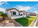 Beautiful single-story home with desert landscaping, lush green lawn, and a cozy front patio at 11307 E Ellis St, Mesa, AZ 85207