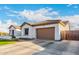 Well-maintained home with a spacious driveway leading to an attached two-car garage at 11307 E Ellis St, Mesa, AZ 85207