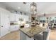 Bright kitchen with stainless steel appliances, white cabinets, and granite counters at 11307 E Ellis St, Mesa, AZ 85207