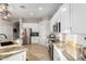 Bright kitchen with stainless steel appliances, white cabinets, and granite counters at 11307 E Ellis St, Mesa, AZ 85207