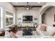 Open living room featuring a modern TV console, wood beams, and arched entrance at 11307 E Ellis St, Mesa, AZ 85207