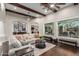 Bright, open living room featuring ceiling fan and a large window with bench seat at 11307 E Ellis St, Mesa, AZ 85207