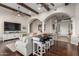 Bright, open living room featuring ceiling fan, wood beams, and arched doorways at 11307 E Ellis St, Mesa, AZ 85207