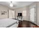 Main bedroom features a ceiling fan, dark wood floors, and doorway to back yard at 11307 E Ellis St, Mesa, AZ 85207