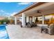 Spacious covered patio with comfortable seating, perfect for outdoor dining and relaxing by the poolside with ceiling fan at 11307 E Ellis St, Mesa, AZ 85207