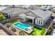 Aerial view of a pool, putting green, covered patio, desert landscaping, and gray roof at 1143 N Quinn --, Mesa, AZ 85205