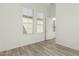 Bright bedroom featuring two windows, neutral walls, and wood-look floors at 1143 N Quinn --, Mesa, AZ 85205