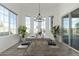 Staged dining room with modern chandelier, and sliding glass doors to backyard pool at 1143 N Quinn --, Mesa, AZ 85205