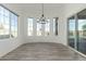 Bright dining room with modern chandelier, and sliding glass doors to backyard pool at 1143 N Quinn --, Mesa, AZ 85205