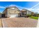 Lovely home exterior with a brick driveway and a well-maintained lawn under a clear blue sky at 1143 N Quinn --, Mesa, AZ 85205