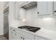 Up close image of kitchen backsplash, white cabinets, and stainless steel gas range at 1143 N Quinn --, Mesa, AZ 85205