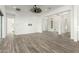 Bright living room with hardwood floors, white walls, and modern ceiling fan at 1143 N Quinn --, Mesa, AZ 85205