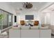 Bright living room with ceiling fan, light walls, and sliding doors to the outside at 1143 N Quinn --, Mesa, AZ 85205