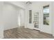 Inviting living area with hardwood floors, natural light, and an open layout leading to the kitchen at 1143 N Quinn --, Mesa, AZ 85205