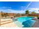 A luxurious pool and spa area, enclosed with a safety fence and desert landscaping at 1143 N Quinn --, Mesa, AZ 85205