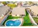 Aerial view of backyard with swimming pool, patio, playground, and artificial turf at 11843 W Cambridge Ave, Avondale, AZ 85392